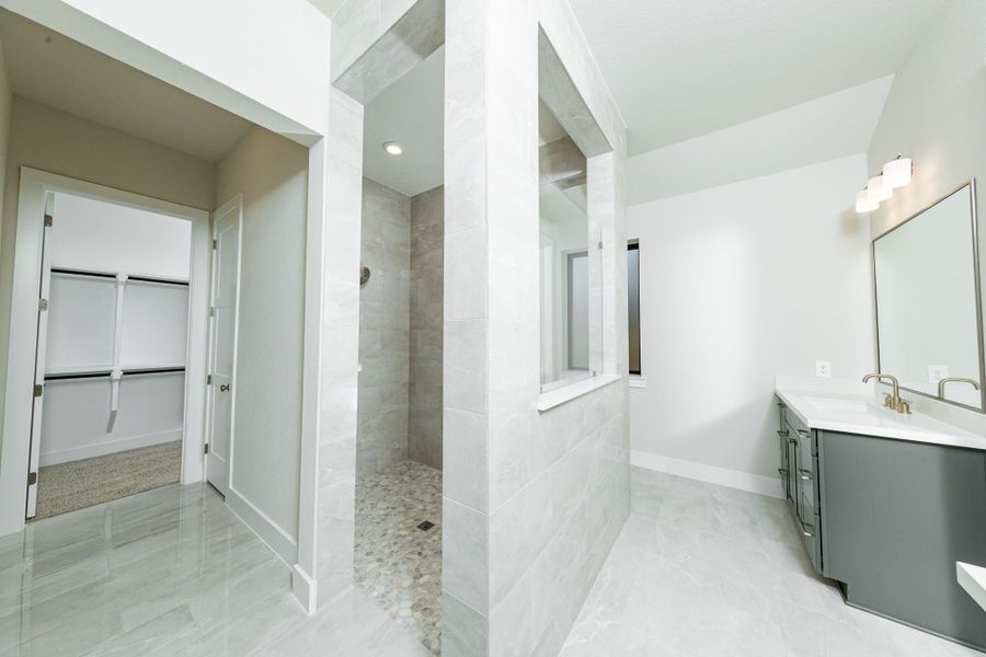 The walk-in shower boats of stylish tile surround and a pebble mosaic tile flooring. The walk-in shower boats of stylish tile surround and a pebble mosaic tile flooring.