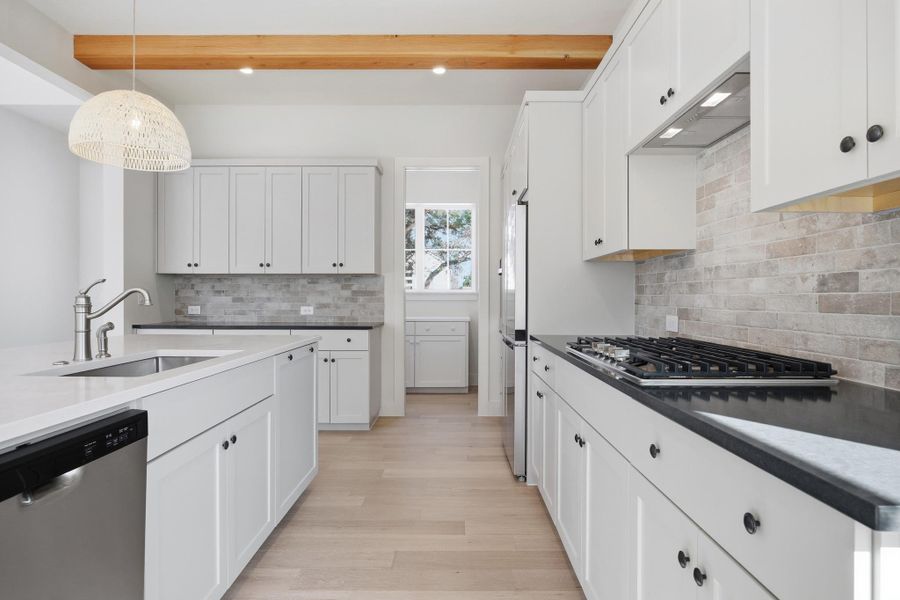 Kitchen with quartz countertops and walk-in pantry