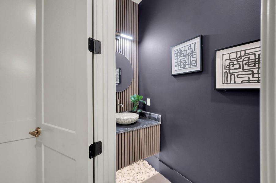 A beautifully appointed powder bath showcases elevated finishes and thoughtful design, offering both convenience and a touch of sophistication for guests.
