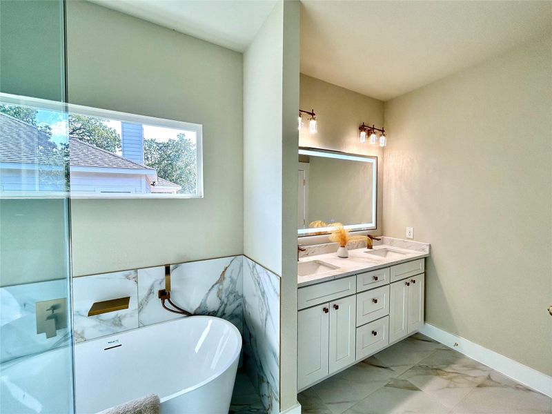 Primary bathroom with lighted mirror