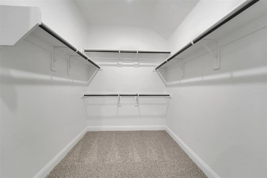 Spacious closet with carpet floors and attic access