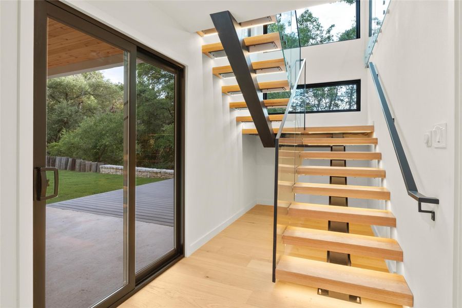 Floating staircase with glass and iron railings