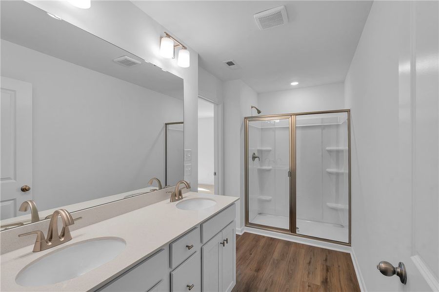 Modern bathroom featuring dual sinks and a spaciou Modern bathroom featuring dual sinks and a spaciou