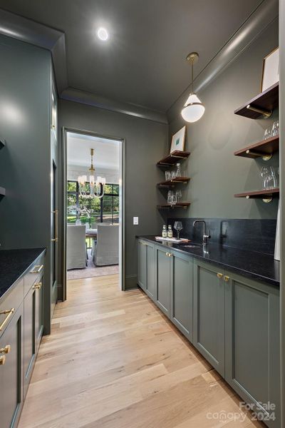 Butlers pantry and wet bar between dining room and kitchen,