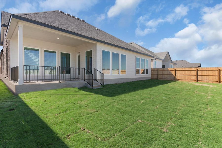 Back of house featuring a patio area, a shingled roof, and a fenced backyard