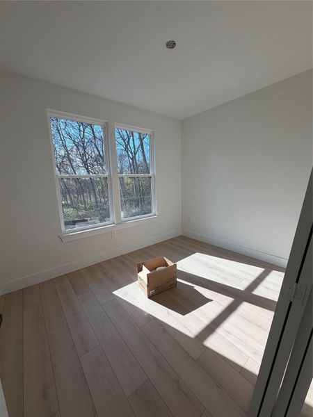 Unfurnished room with baseboards and light wood-style floors