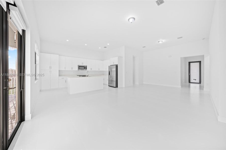 Great Room (view of dining, living, kitchen, door to 1/2 bath and laundry)