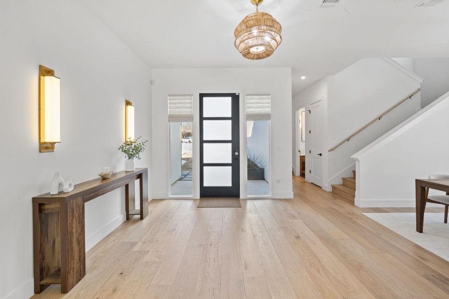 Entryway with light wood-style flooring and recessed lighting