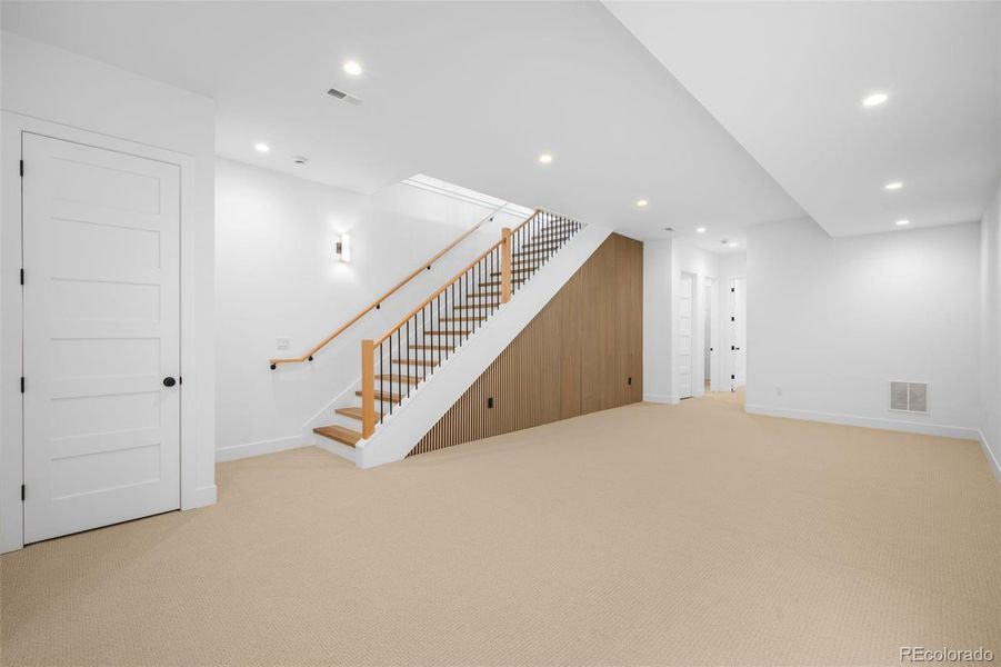 Acoustic wood slat panel accent wall that is also functional for sound improvement within the space, great for a theatre room or movie nights!