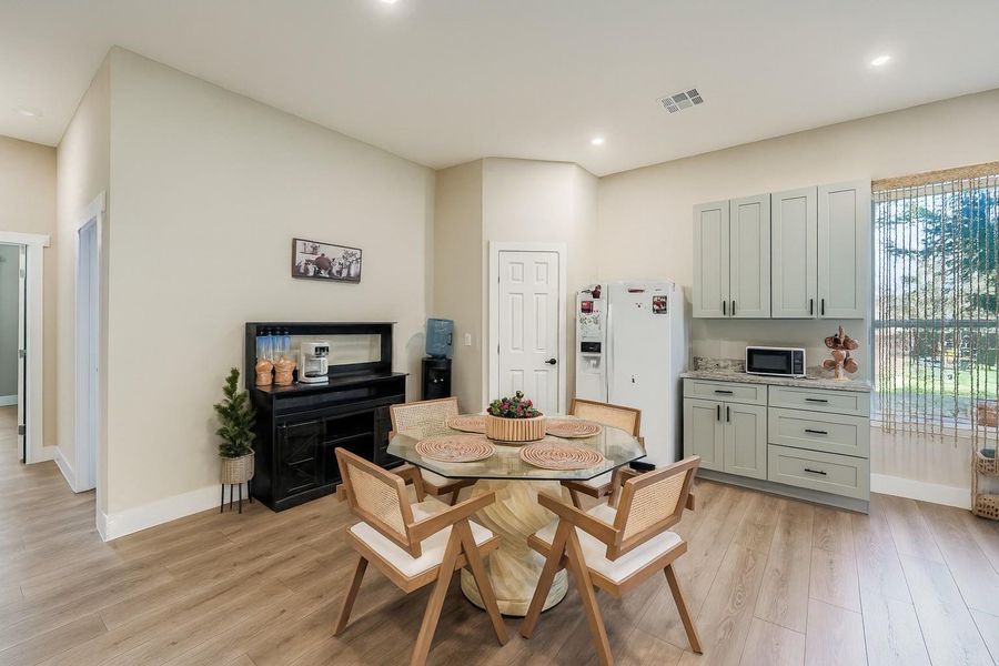 Dining room featuring light wood-style floors and recessed lighting Dining room featuring light wood-style floors and recessed lighting