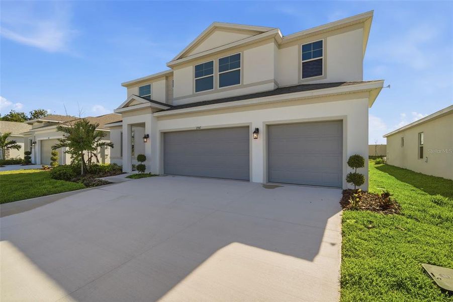 Front exterior of a new home in Fieldstone, Plant City, FL, highlighting curb appeal (Image 30).