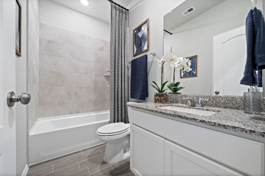 A bathroom with a marble countertop.