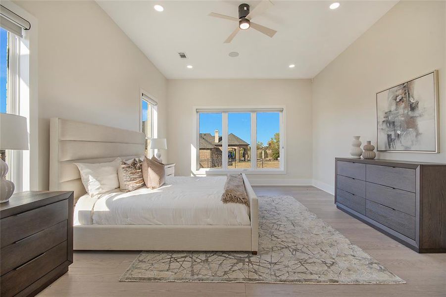 Bedroom featuring ceiling fan, light wood-style flooring, and recessed lighting Bedroom featuring ceiling fan, light wood-style flooring, and recessed lighting