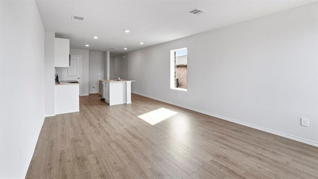 Unfurnished living room featuring light wood-type flooring and recessed lighting Unfurnished living room featuring light wood-type flooring and recessed lighting