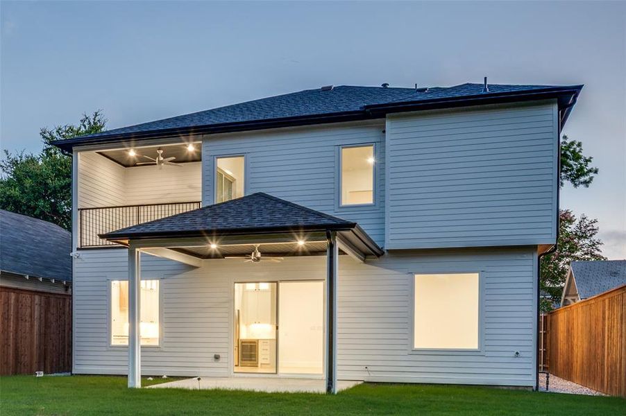 Rear view of property with a ceiling fan and a shingled roof
