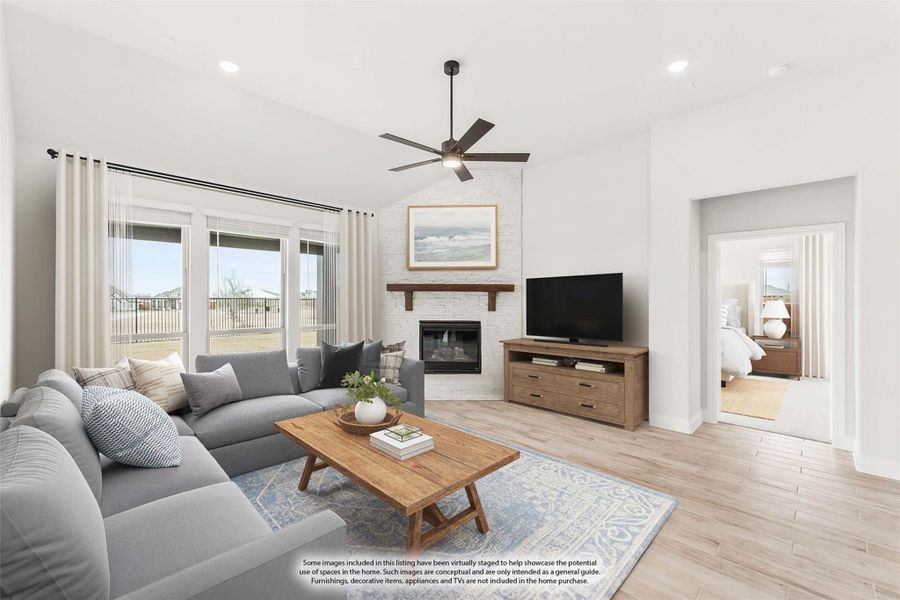 Living room with gray sectional sofa, white brick fireplace, ceiling fan, and light hardwood floors Living room with gray sectional sofa, white brick fireplace, ceiling fan, and light hardwood floors