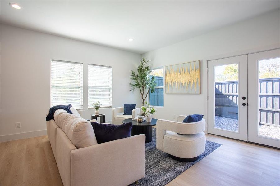 Living room featuring light wood-type flooring and french doors