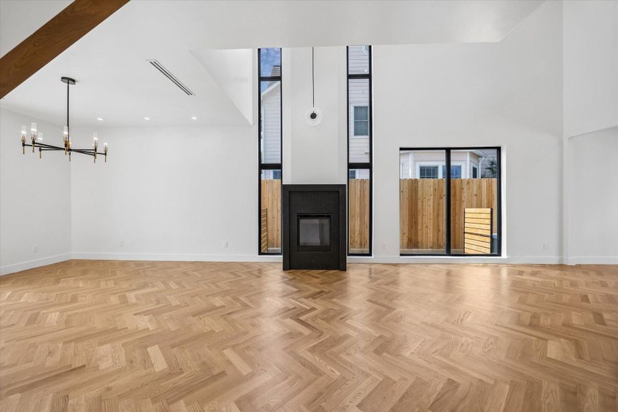 Striking floor-to-ceiling fireplace with an elegant oversized pendant serves as the focal point of the living room. Striking floor-to-ceiling fireplace with an elegant oversized pendant serves as the focal point of the living room.