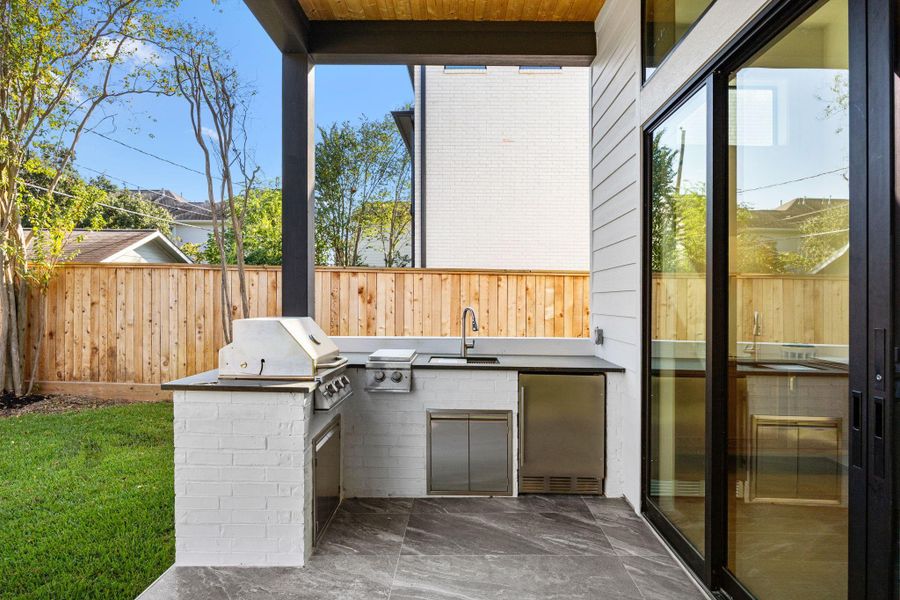 Summer Kitchen built out on the 1st floor covered patio. Includes gas grill, griddle, sink & fridge! Summer Kitchen built out on the 1st floor covered patio. Includes gas grill, griddle, sink & fridge!