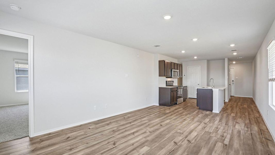 An open-concept living area with seamless flow into the kitchen. An open-concept living area with seamless flow into the kitchen.