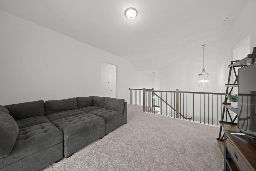 The upstairs game room is ideal for relaxation or a small entertainment area.