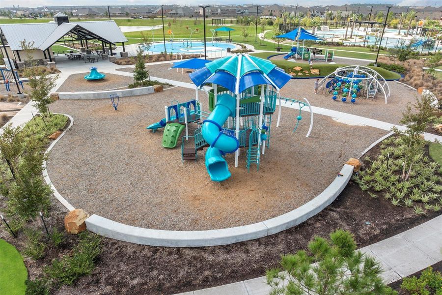 Thoughtfully designed play equipment set on soft surfaces, surrounded by open green space.