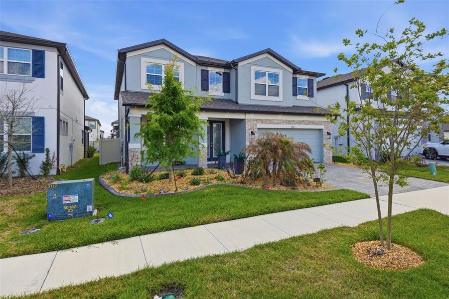 Front exterior of a new home in Whispering Oaks Preserve, Wesley Chapel, FL, highlighting curb appeal (Image 29). Front exterior of a new home in Whispering Oaks Preserve, Wesley Chapel, FL, highlighting curb appeal (Image 29).