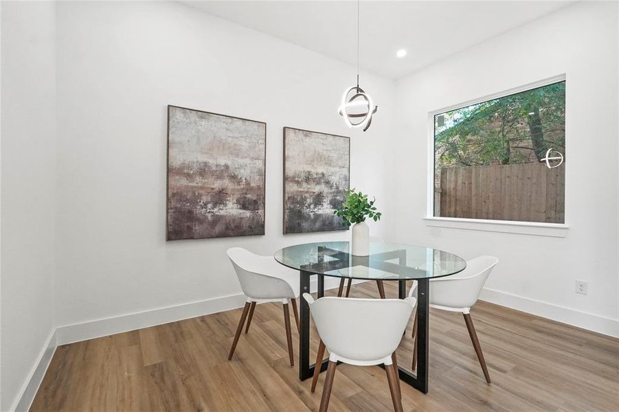 Dining space featuring wood finished floors and recessed lighting