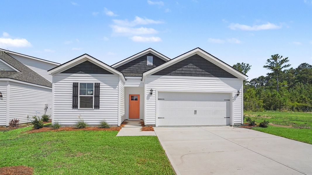 Front exterior of a new home in The Meadows at Wildwood Village, Shallotte, NC, highlighting curb appeal (Image 2).