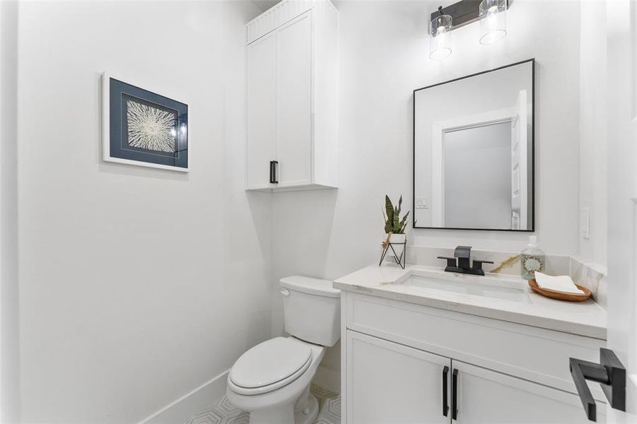 Half bathroom featuring toilet and vanity