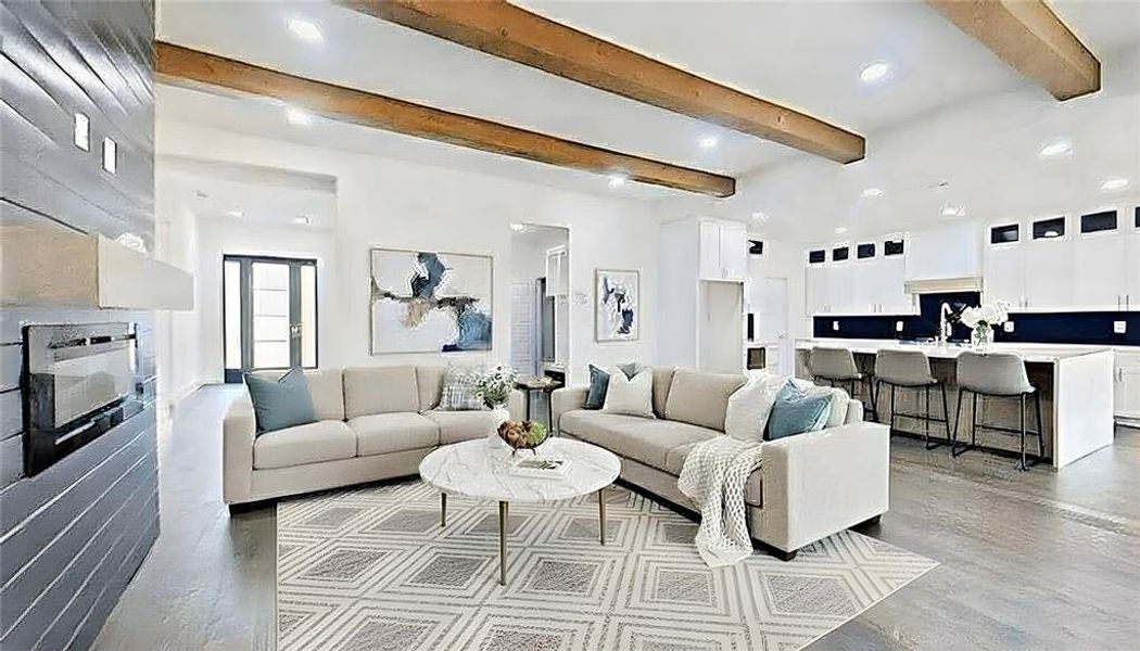 Living room with beamed ceiling, finished concrete flooring, and recessed lighting