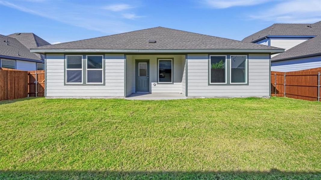Back of house featuring roof with shingles, a fenced backyard, and a patio area Back of house featuring roof with shingles, a fenced backyard, and a patio area