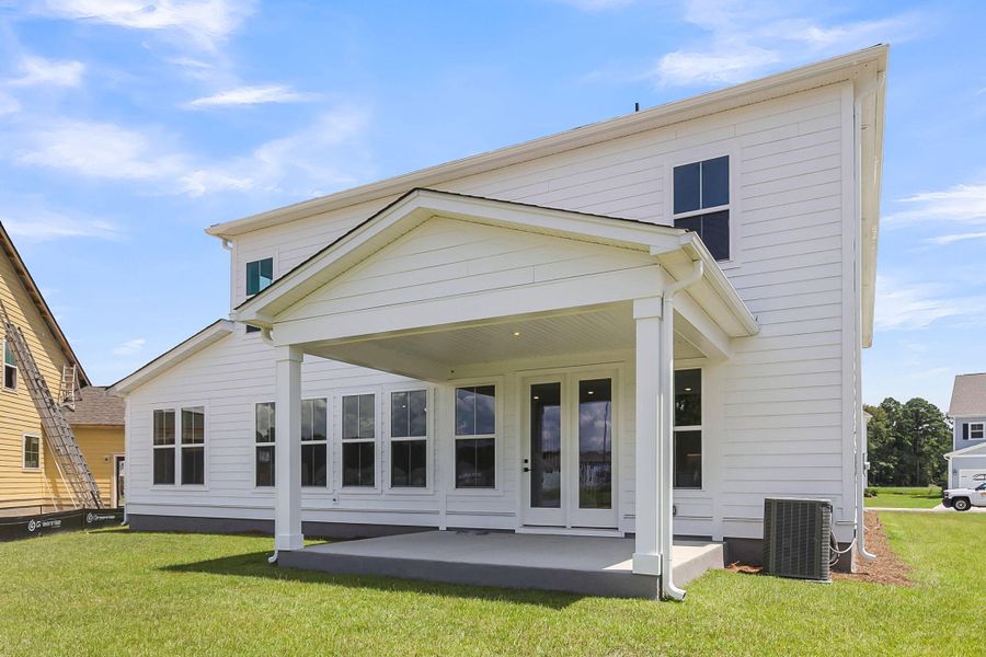 Front exterior of a new home in Tidewater at Lakes of Cane Bay, Summerville, SC, highlighting curb appeal (Image 25).