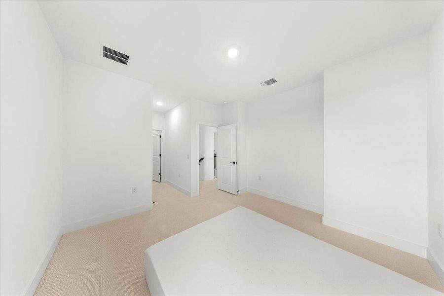 Unfurnished bedroom featuring light colored carpet and recessed lighting Unfurnished bedroom featuring light colored carpet and recessed lighting