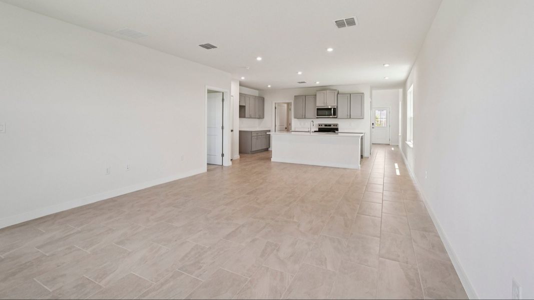 Living Area with View of the Kitchen in the Jupiter in Hamilton Bluff located in Haines City, FL.