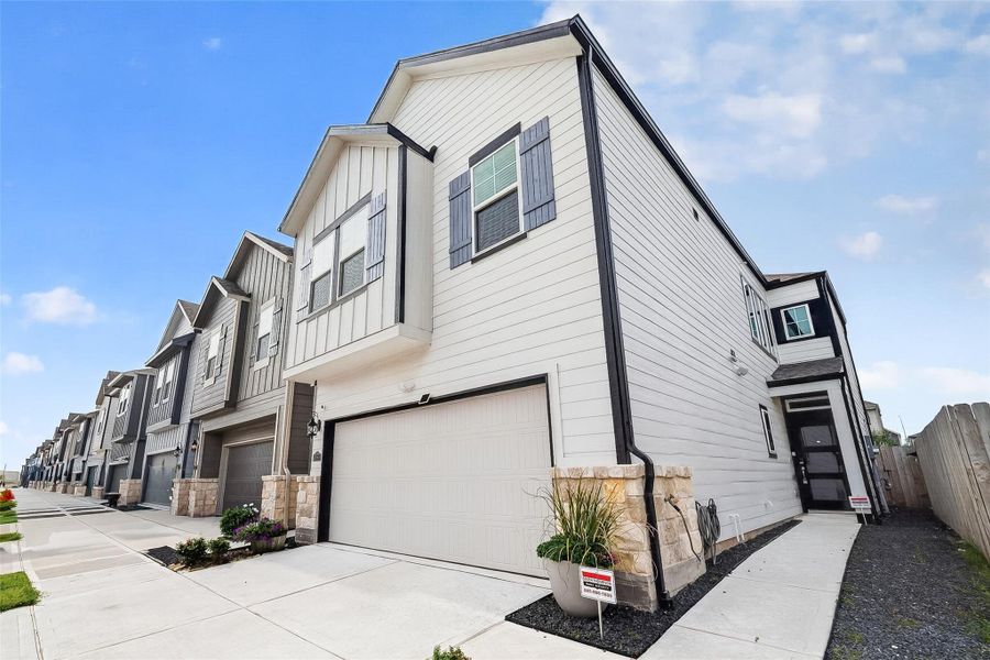 Front exterior of a new home in McClendon Park Village, Houston, TX, highlighting curb appeal (Image 23).
