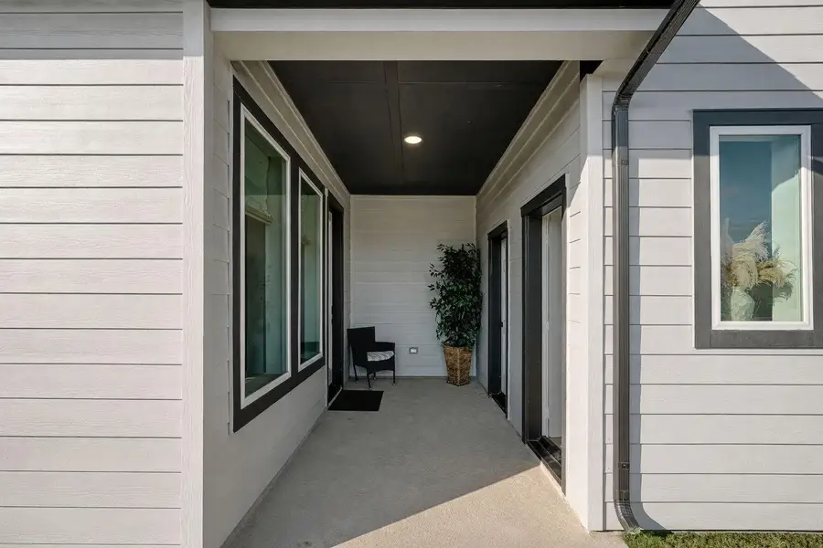 Covered breezeway connecting the main home to the garage apartment, creating a private, sheltered entry perfect for everyday convenience and seamless multi-generational living.