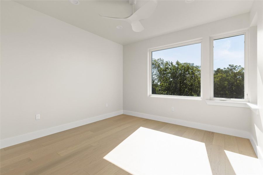 Clean lines and light hardwood flooring define this versatile second-story space.