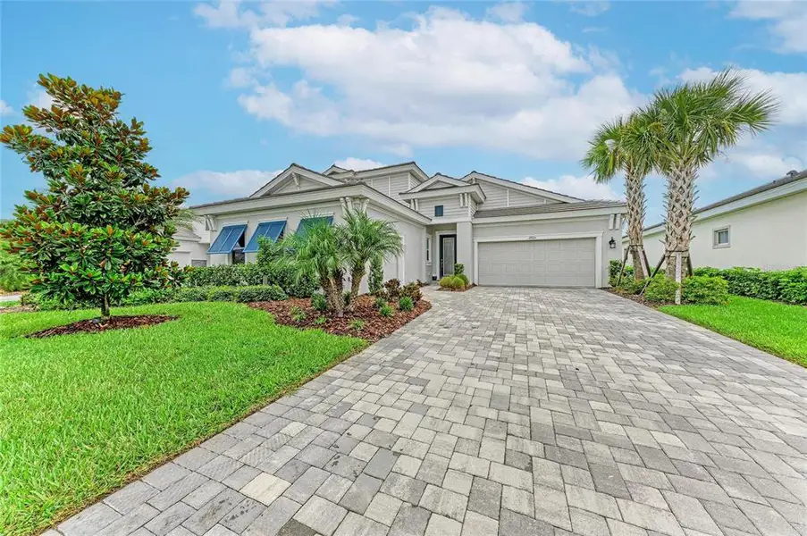 Front exterior of a new home in Star Farms at Lakewood Ranch, Lakewood Ranch, FL, highlighting curb appeal (Image 26). Front exterior of a new home in Star Farms at Lakewood Ranch, Lakewood Ranch, FL, highlighting curb appeal (Image 26).