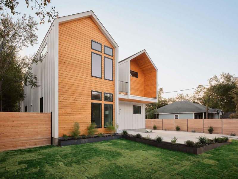 Back of house with a balcony and a fenced backyard Back of house with a balcony and a fenced backyard