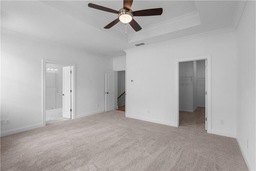 Primary bedroom with double doors leading into the bedroom and bathroom - massive walk in closet. Yay! Pictures represent a previously built home