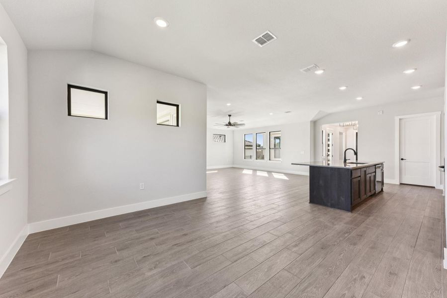 Unfurnished living room featuring recessed lighting, light wood finished floors, and a ceiling fan Unfurnished living room featuring recessed lighting, light wood finished floors, and a ceiling fan