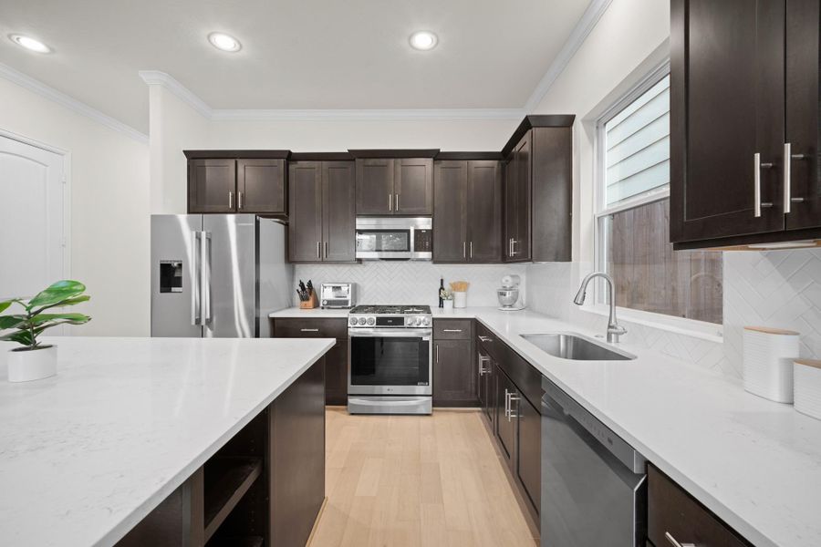LG gas range, quartz perimeter counters, undermount sink, and more cabinet storage than you'll know what to do with — including soft-close drawers throughout. LG gas range, quartz perimeter counters, undermount sink, and more cabinet storage than you'll know what to do with — including soft-close drawers throughout.
