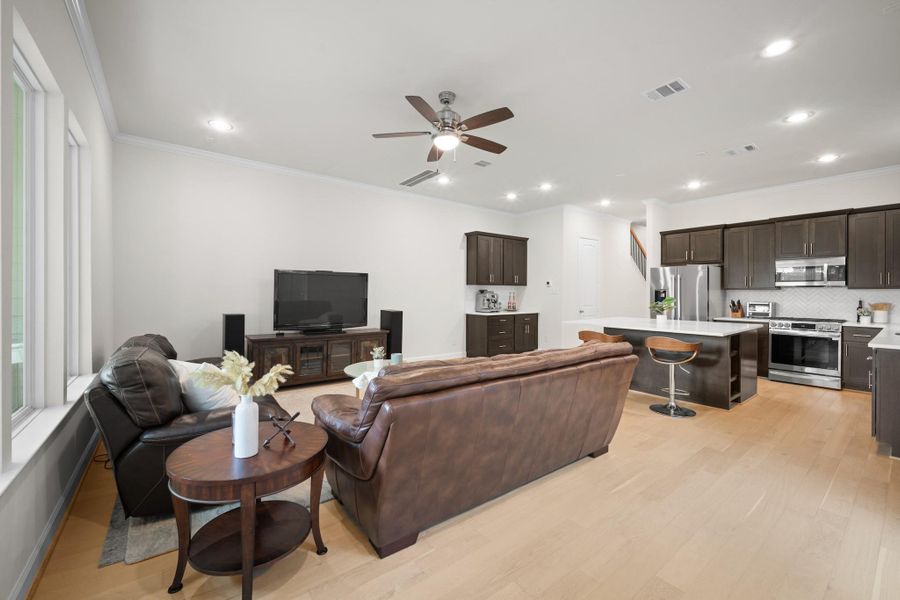 The full sweep of the first floor, living room to kitchen, shows how well this floor plan lives — open enough to feel connected, defined enough to feel intentional. The full sweep of the first floor, living room to kitchen, shows how well this floor plan lives — open enough to feel connected, defined enough to feel intentional.