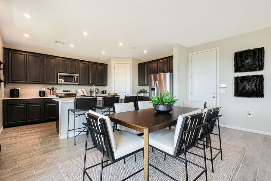 A kitchen with a dining table.