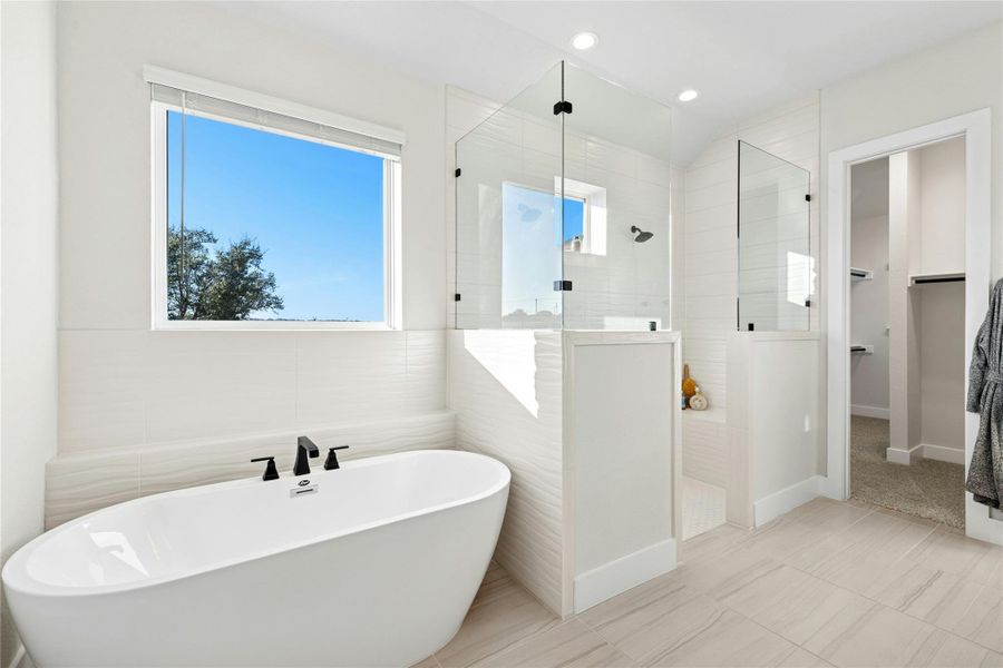 Full bath with a spacious closet, a freestanding bath, a walk in shower, recessed lighting, and tile patterned flooring Full bath with a spacious closet, a freestanding bath, a walk in shower, recessed lighting, and tile patterned flooring
