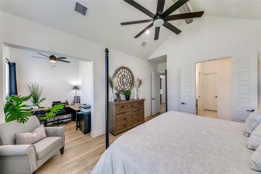 Bedroom featuring cathedral ceiling with beam, ceiling fan, light hardwood / wood-style floors