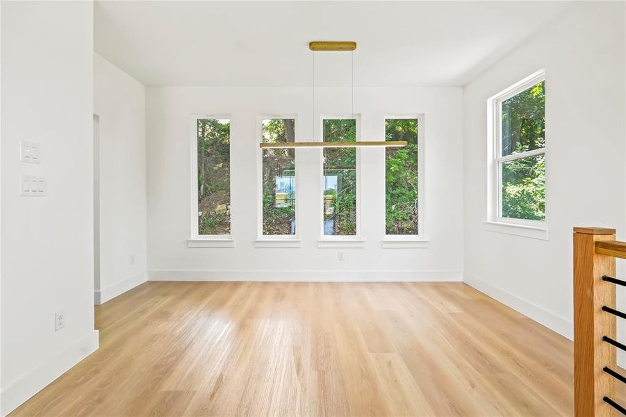 Empty room with plenty of natural light and light wood-style flooring