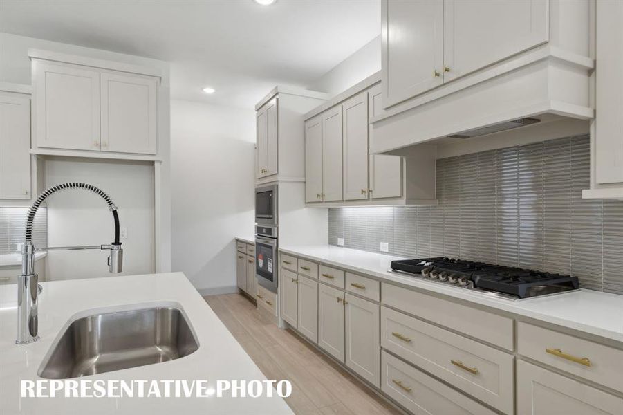 This gorgeous kitchen offers beautiful cabinetry & countertops paired with all of the modern conveniences you are looking for in a dream kitchen.  REPRESENTATIVE PHOTO