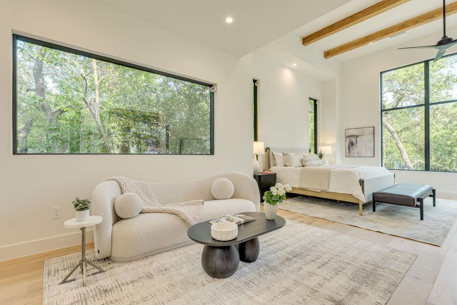 Natural light streams into this generously proportioned room through expansive windows framing verdant views. Natural light streams into this generously proportioned room through expansive windows framing verdant views.
